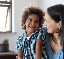 Child Smiling Looking At His Mom