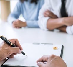 Man And A Woman In An Attorneys Office Signing Divorce Papers